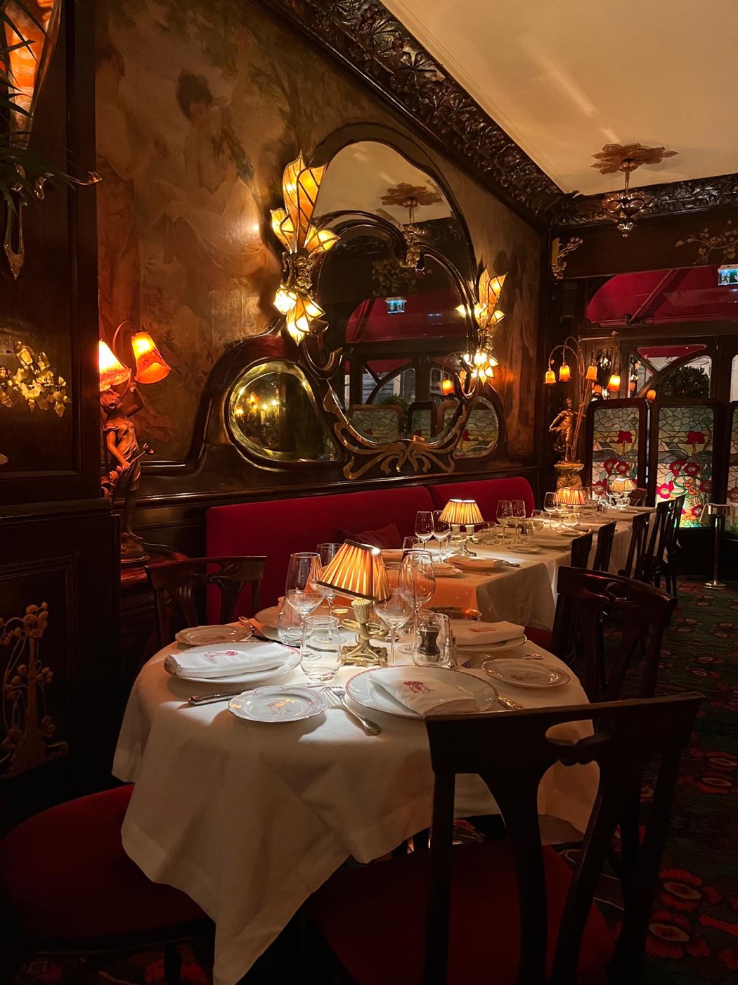 An intimate dining room with warm lighting and carefully set tables.
